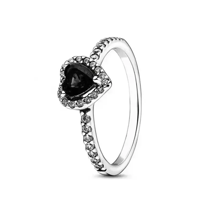 Silver ring with a black heart-shaped gemstone on a white background