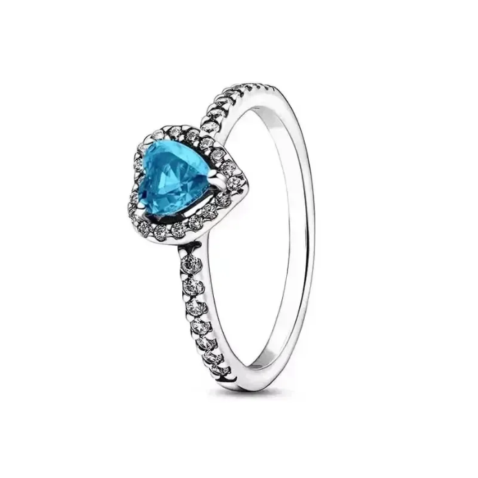 Silver ring with a blue heart-shaped gemstone on a white background
