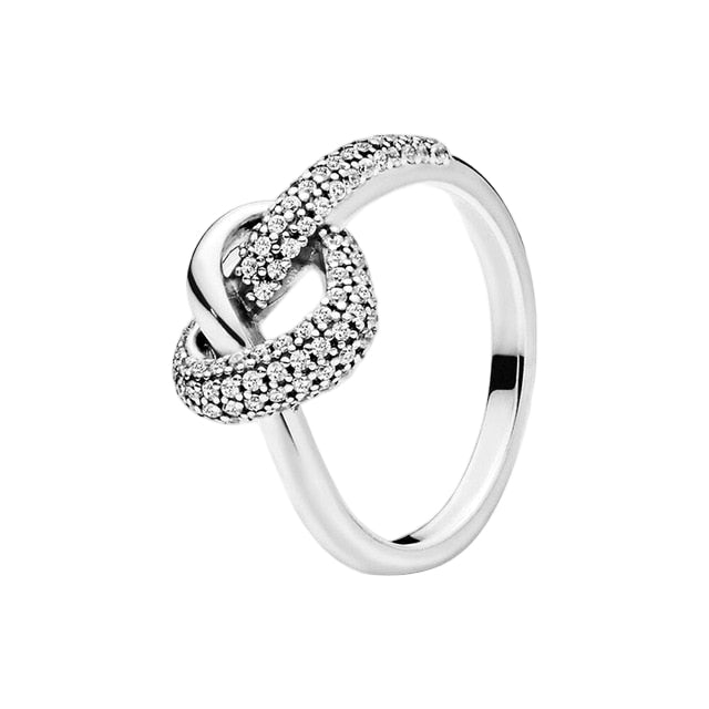 Silver ring with diamond accents on a white background