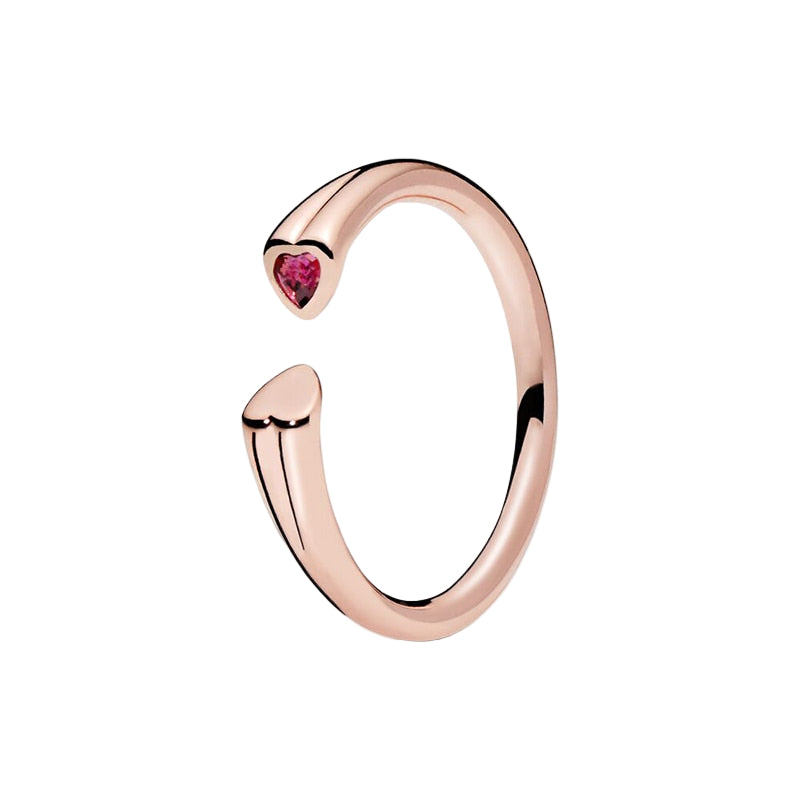 Rose gold ring with a heart-shaped gemstone on a white background