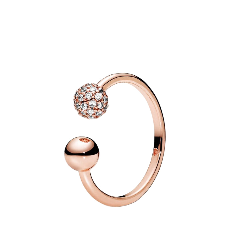Rose gold ring with a spherical design on a white background