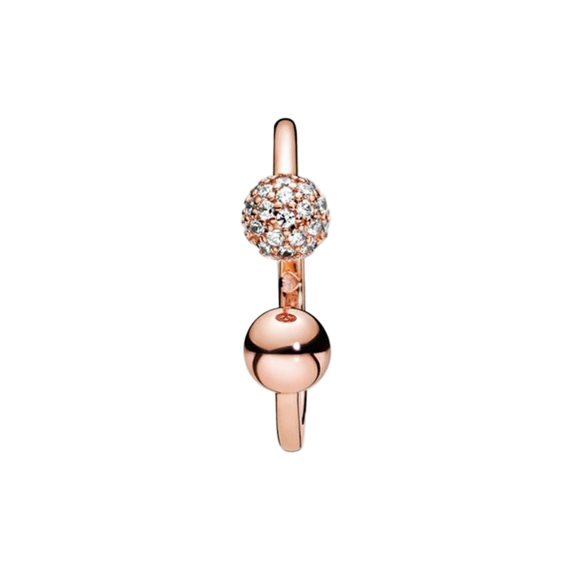 Rose gold ring with a sparkling ball design on a white background