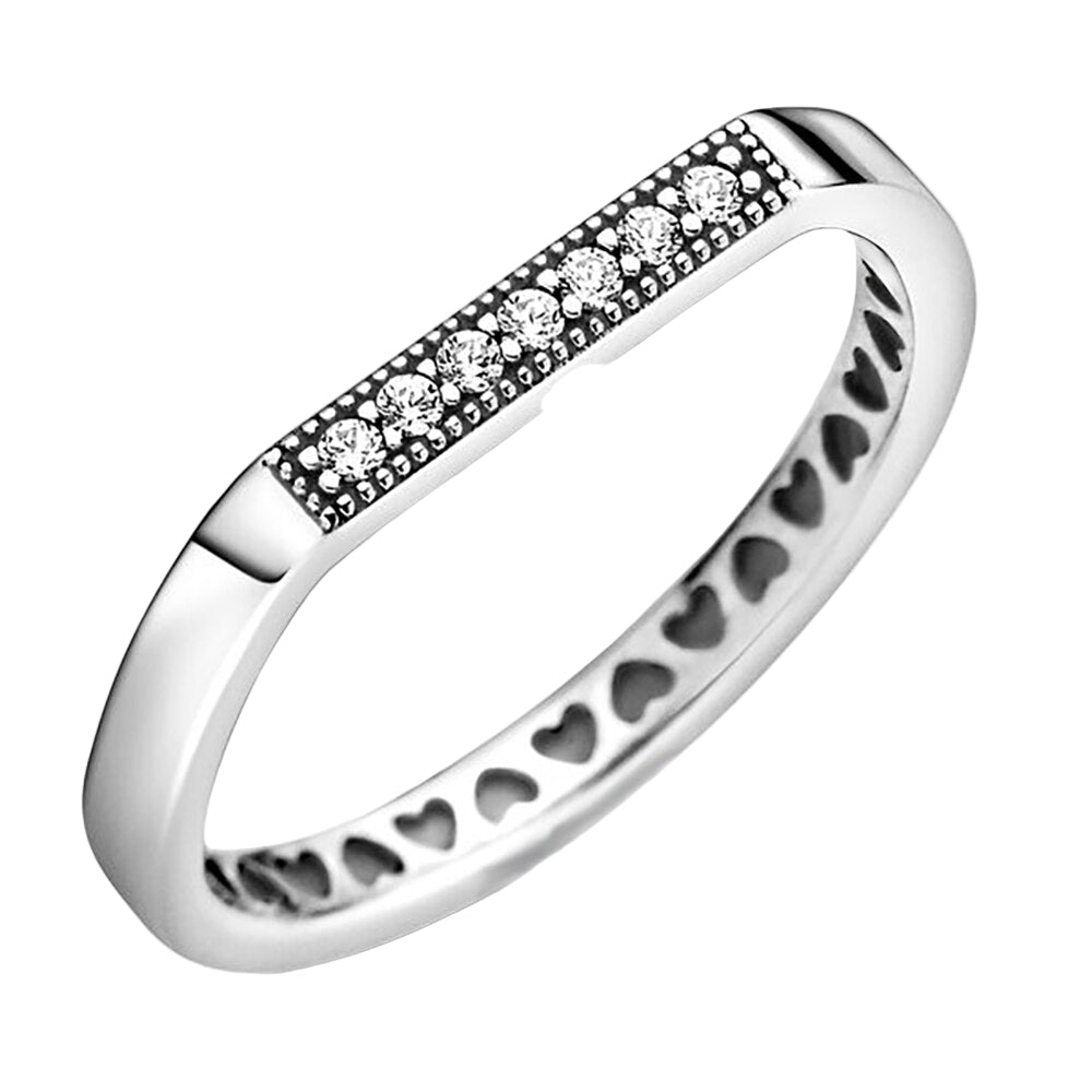 Silver ring with heart patterns and embedded stones on a white background