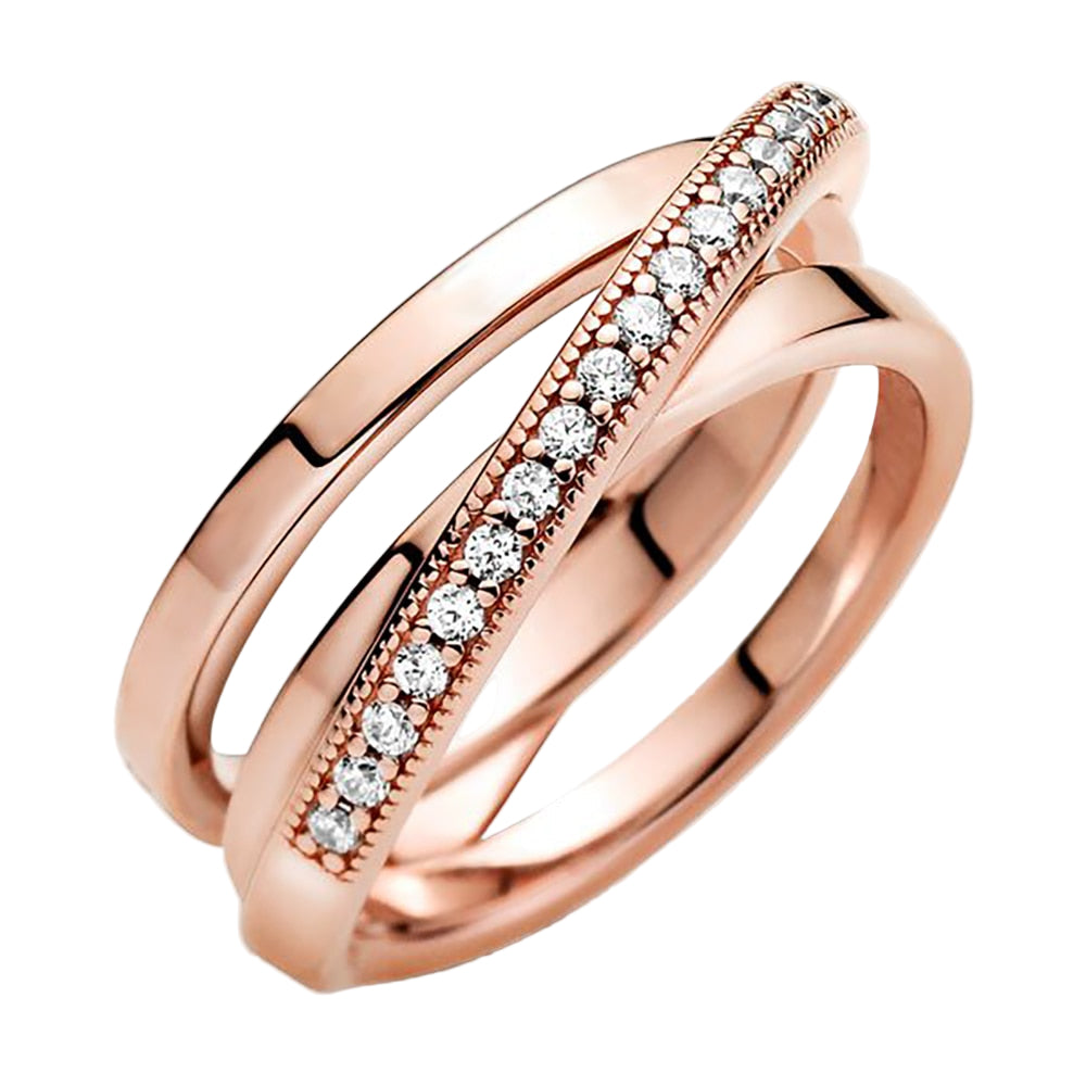 Rose gold ring with diamonds on a white background